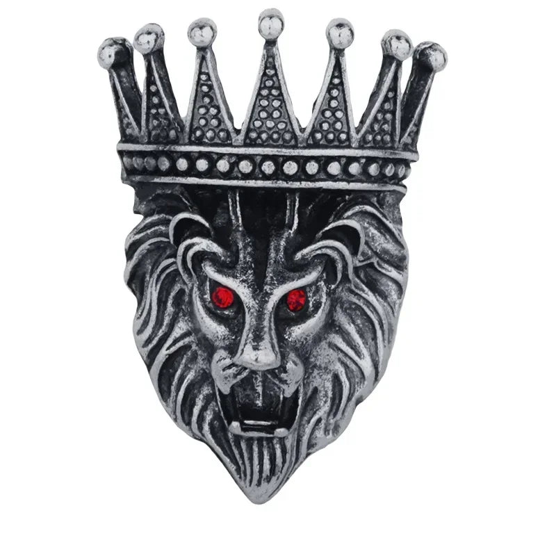 Silver lion head brooch with crown design on white background