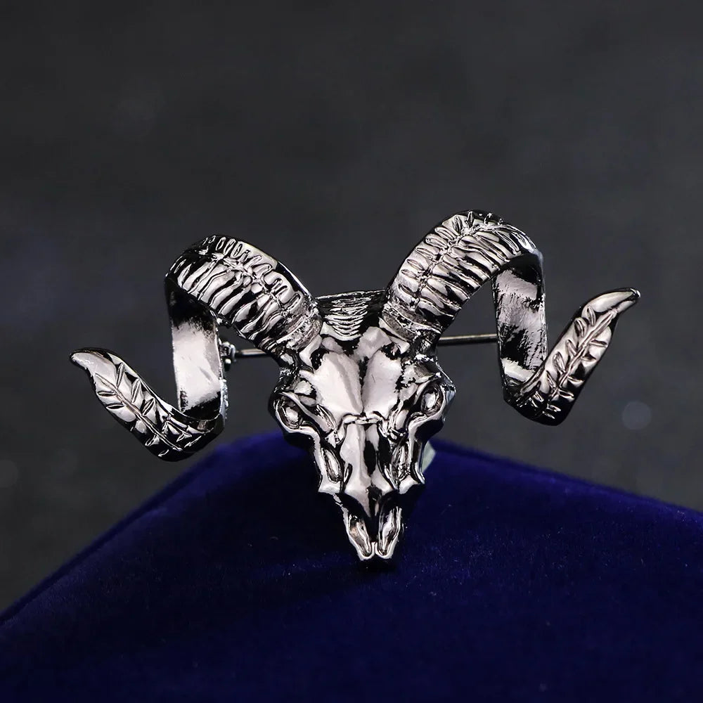 Vintage ram skull lapel pin with intricate animal detailing on a dark backdrop.