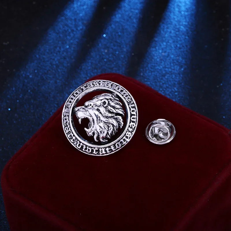 Silver lion emblem lapel pin on red velvet cushion