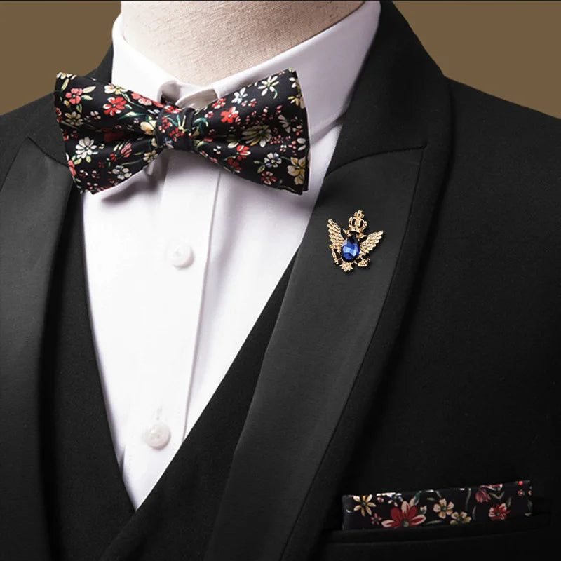 Man wearing black tuxedo with floral bow tie and pocket square formal elegant style
