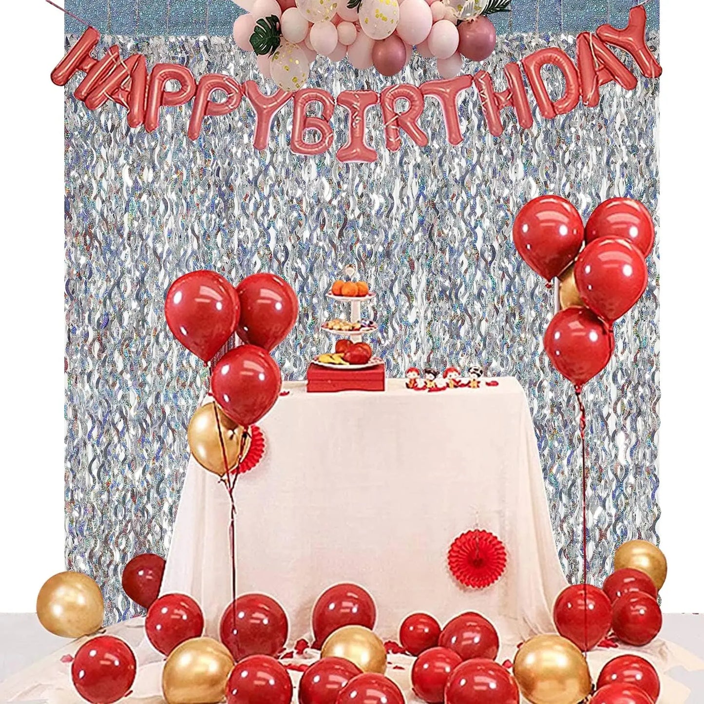 Birthday party backdrop with foil fringe curtain balloons cake table and photo booth decor