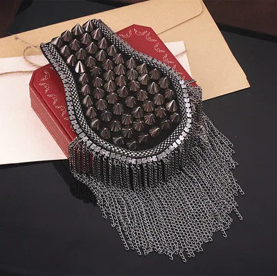 Studded metallic shoulder accessory with chain fringe detailing