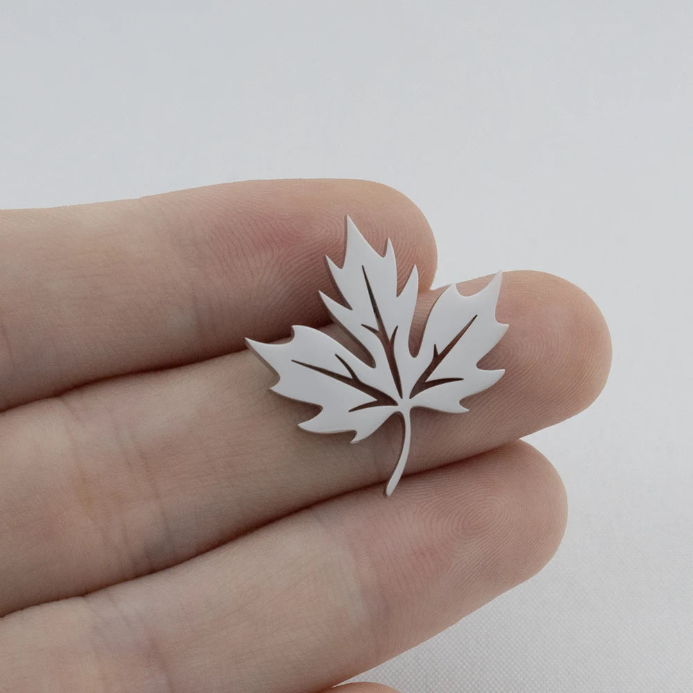 White paper leaf held between fingers against a light background