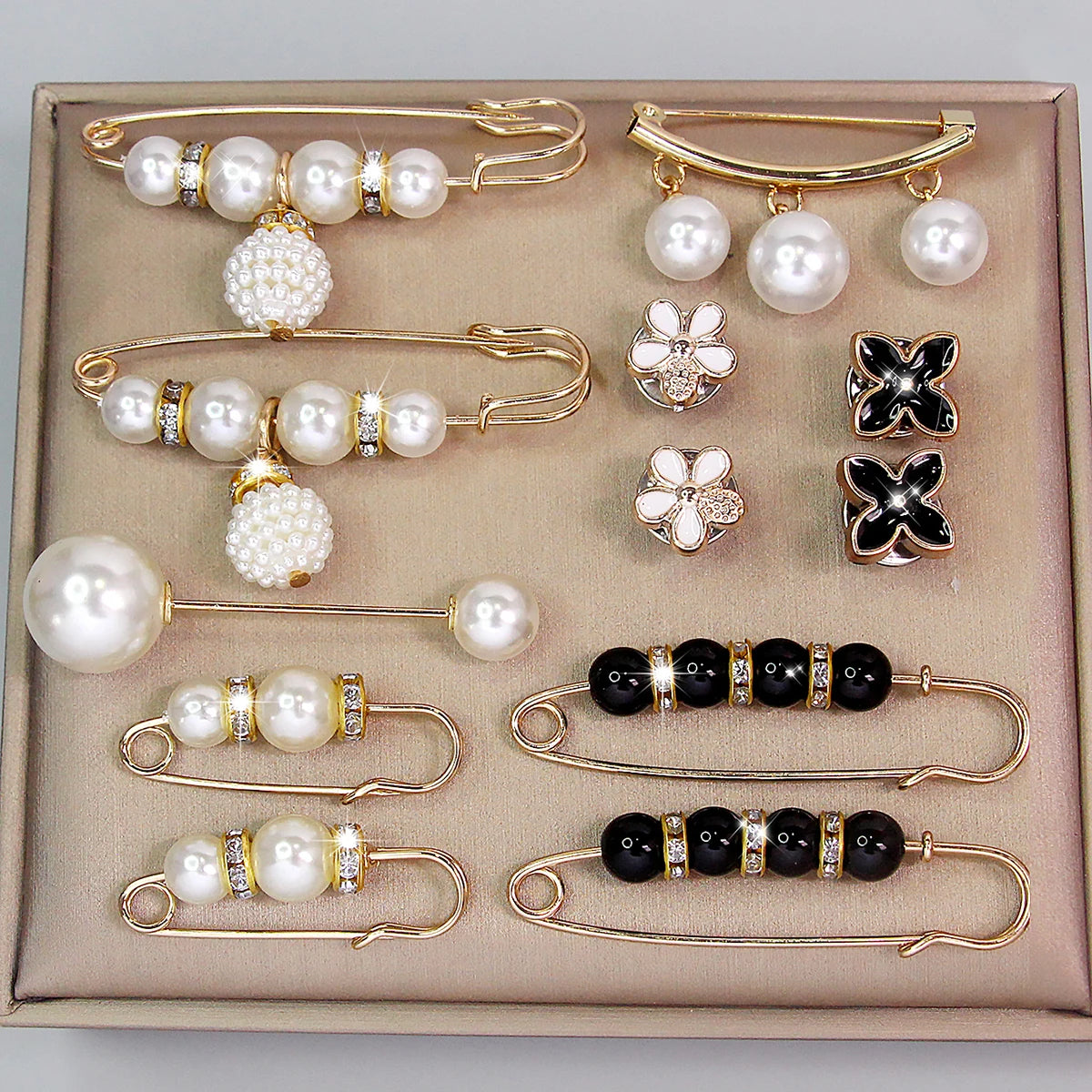 Decorative pearl and crystal brooch collection on neutral background