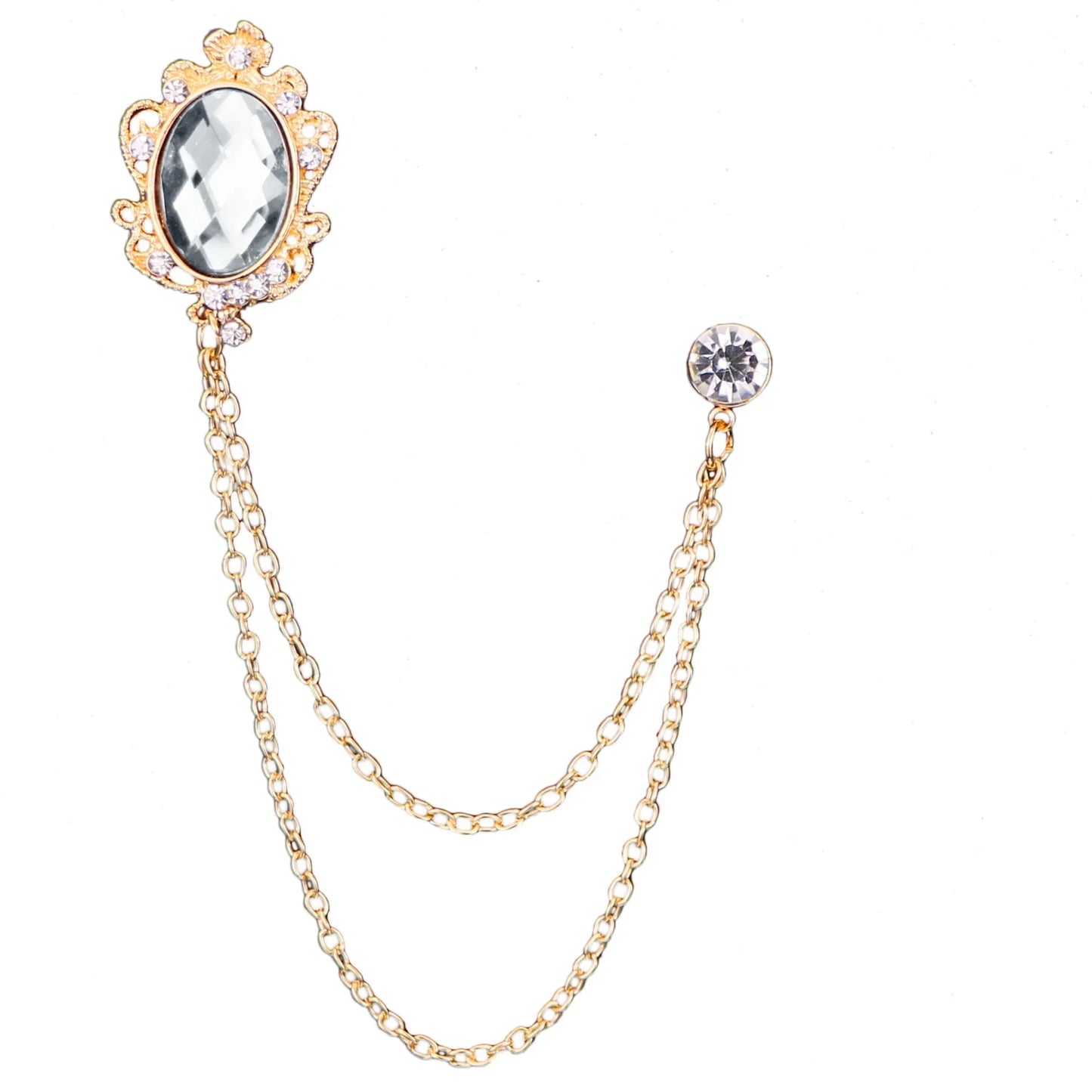 Gold brooch with a chain and gemstone on a white background