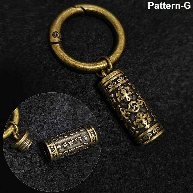 Pattern G engraved mantra capsule brass keychain
