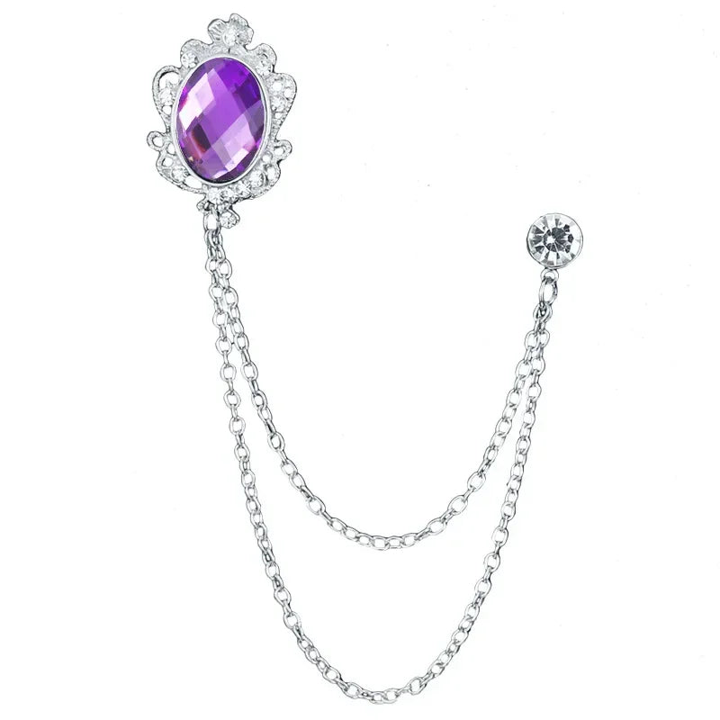 Brooch with purple gem and chain on a white background