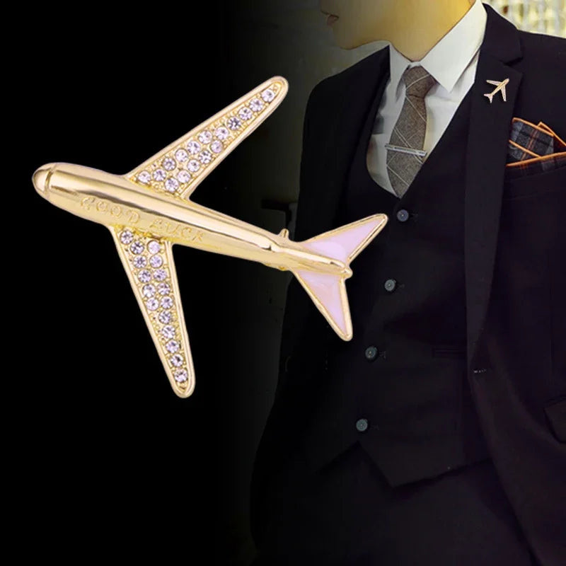 Gold airplane brooch on suit mannequin with matching aviation lapel pin fashion accessory