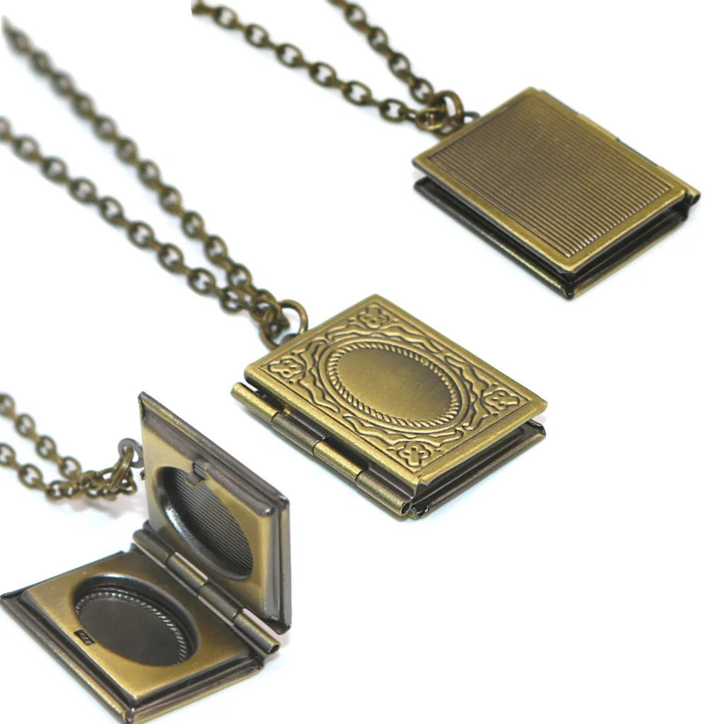 Antique bronze photo locket pendant opened to show picture holder