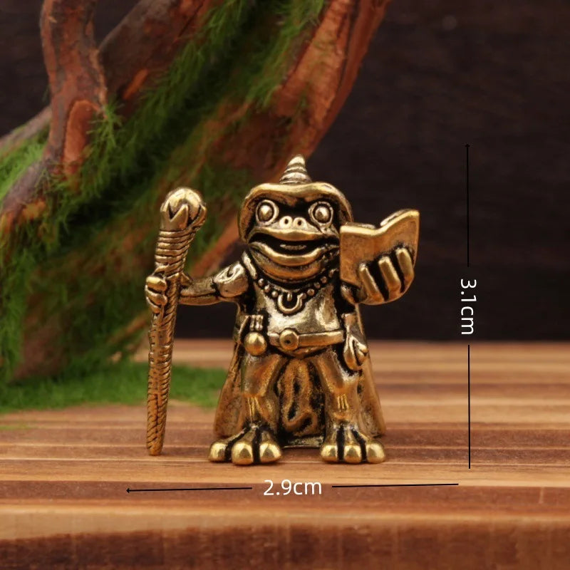 Bronze monkey figurine with measurements on a wooden surface