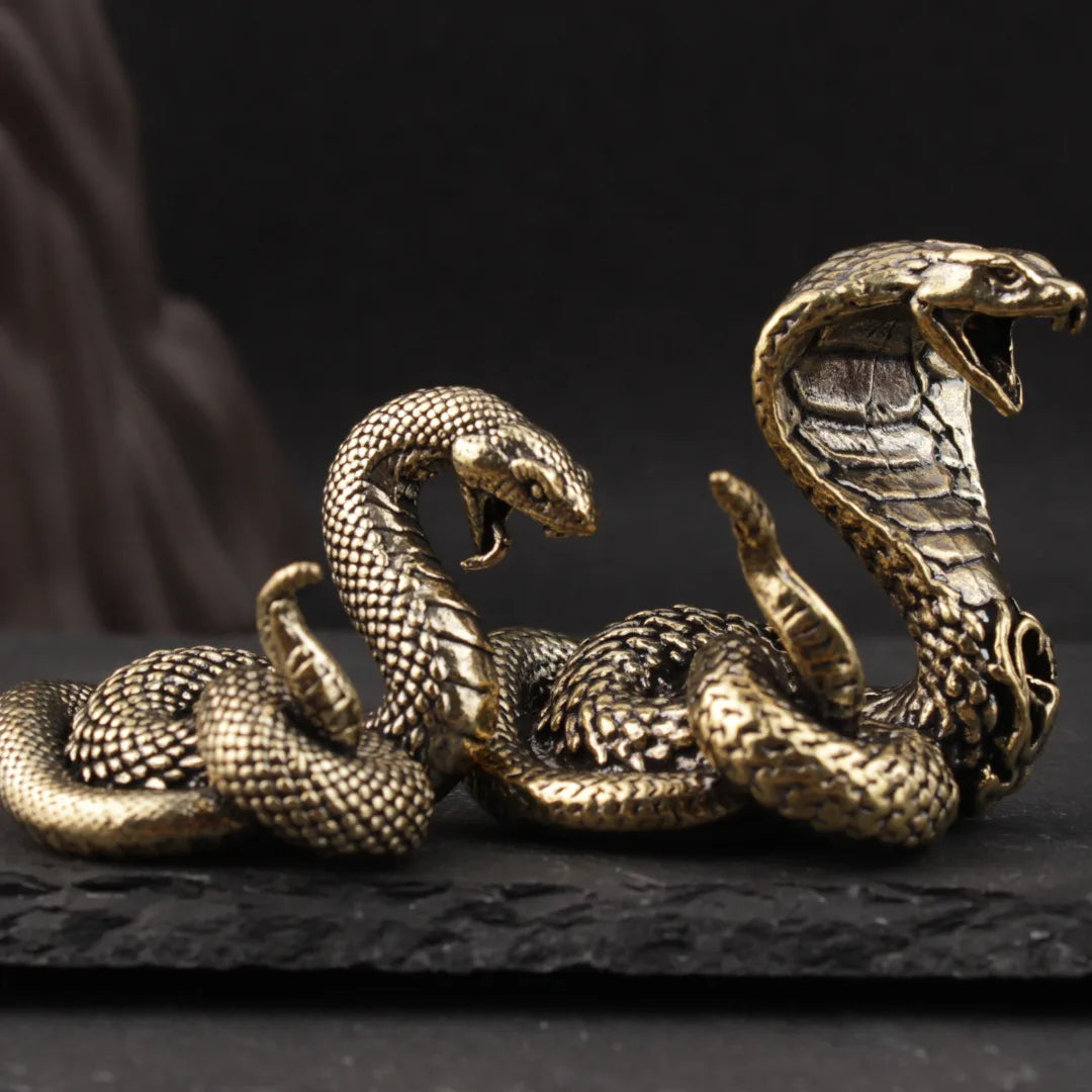 Two Handcrafted brass snake zodiac figurine on display