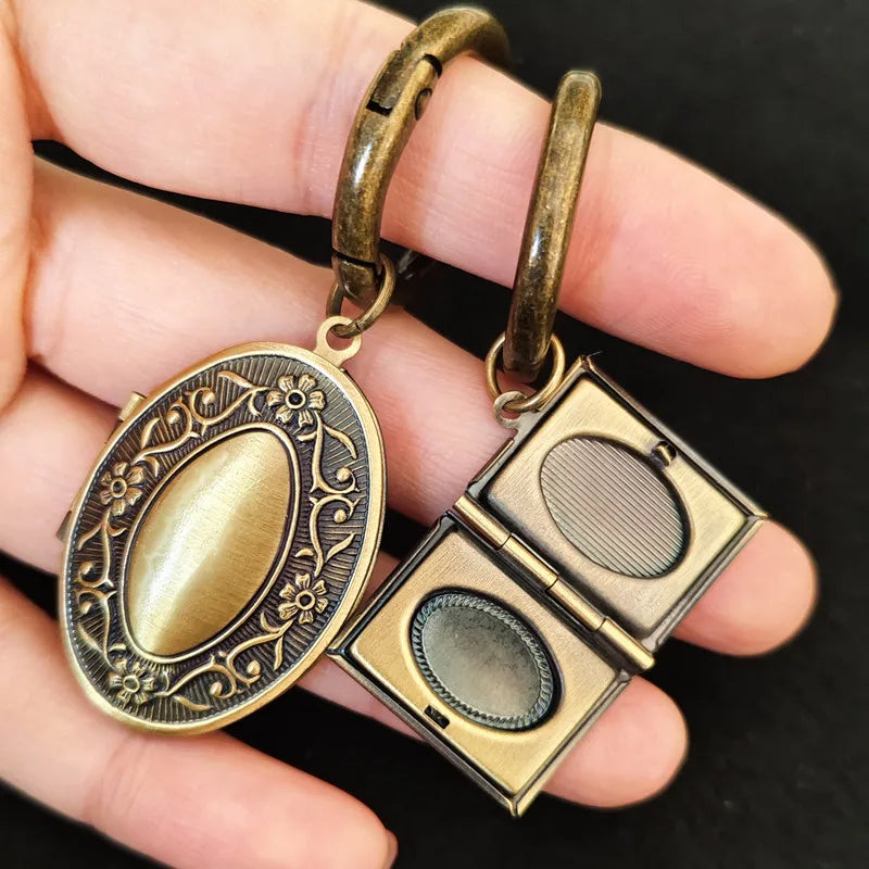Classic keepsake locket keychain in oval and book style designs show in hand