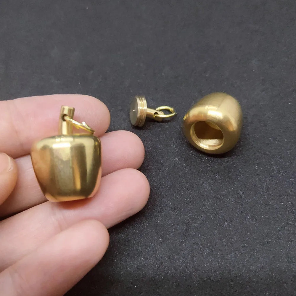 Gold apple-shaped pendant necklace with secret compartment and antique brass finish