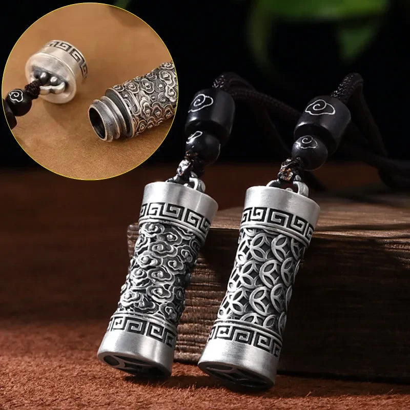 Pair of silver and black beaded necklaces on a wooden surface with close-up detail.