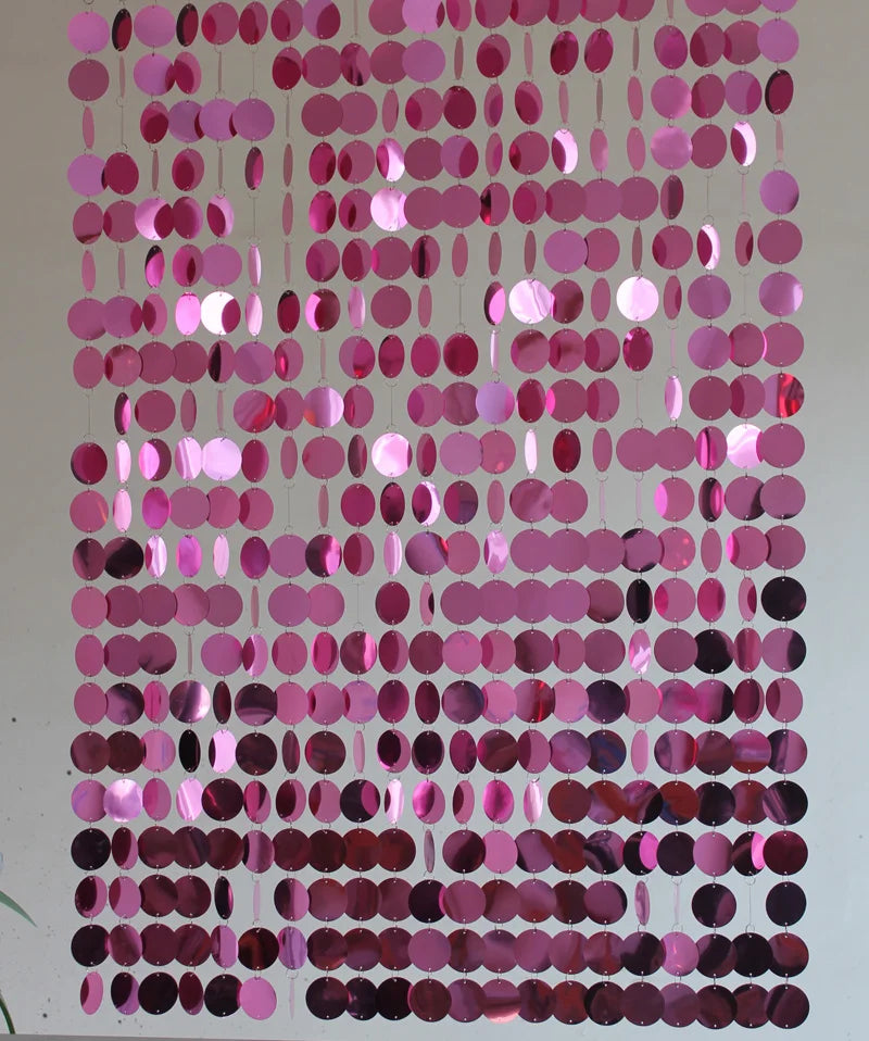 Pink and purple round sequin curtain on a plain background