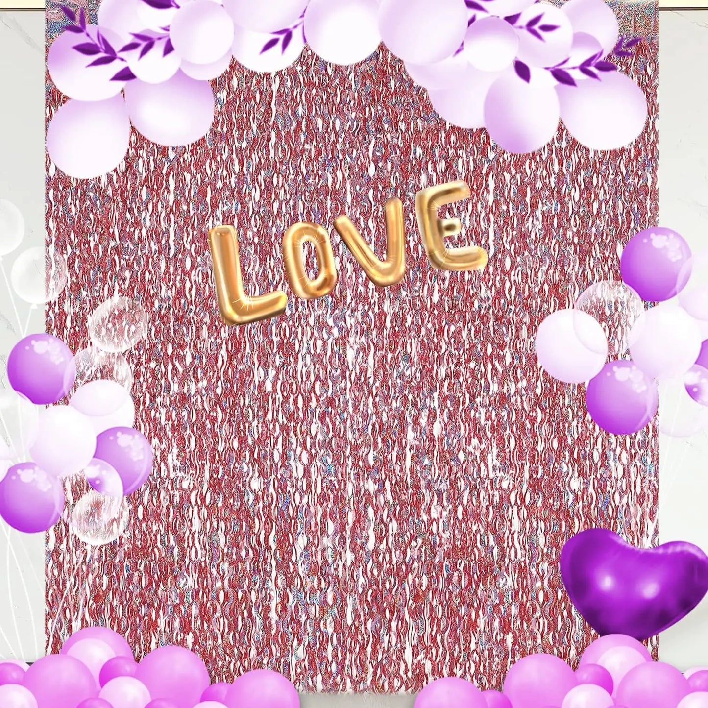 Decorative setup with 'LOVE' balloons, purple and white balloons, and floral elements on a textured backdrop.