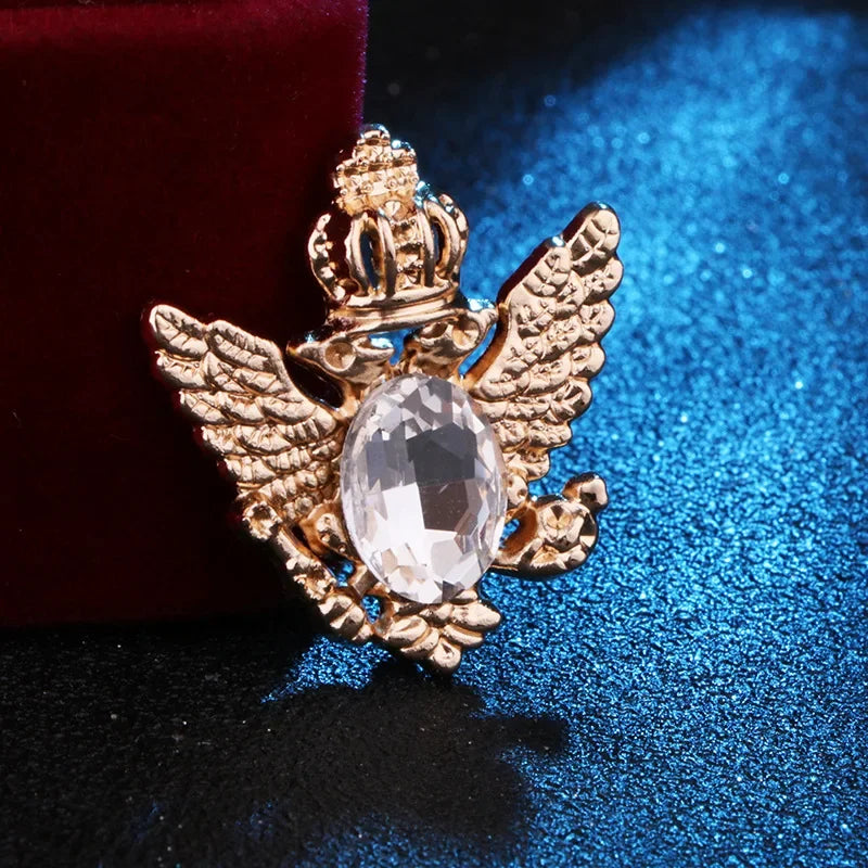 Gold angel pendant with mirror gemstone luxury fashion jewelry on blue and red fabric background