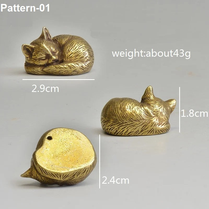 Three gold cat figurines with measurements and weight information on a gray background