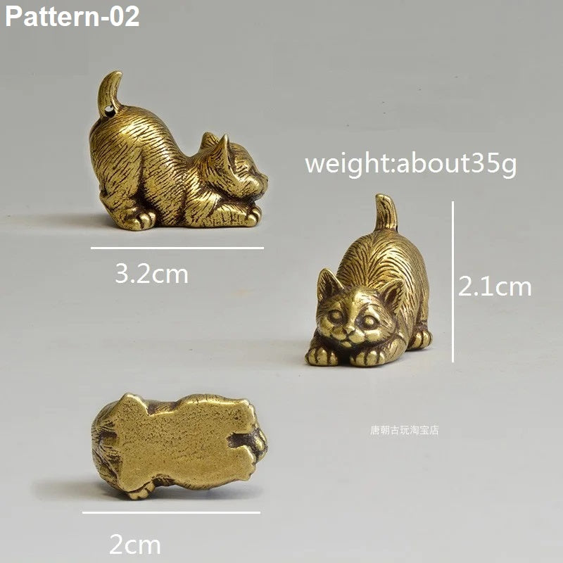 Gold cat figurine with measurements on a gray background