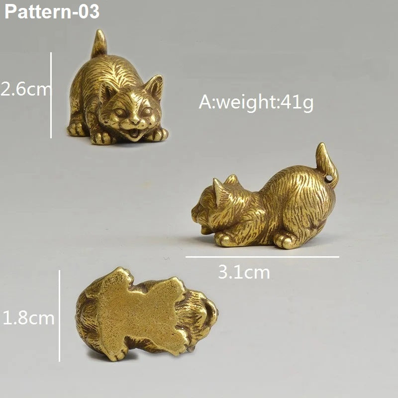 Gold cat figurines with measurements and weight details on a gray background