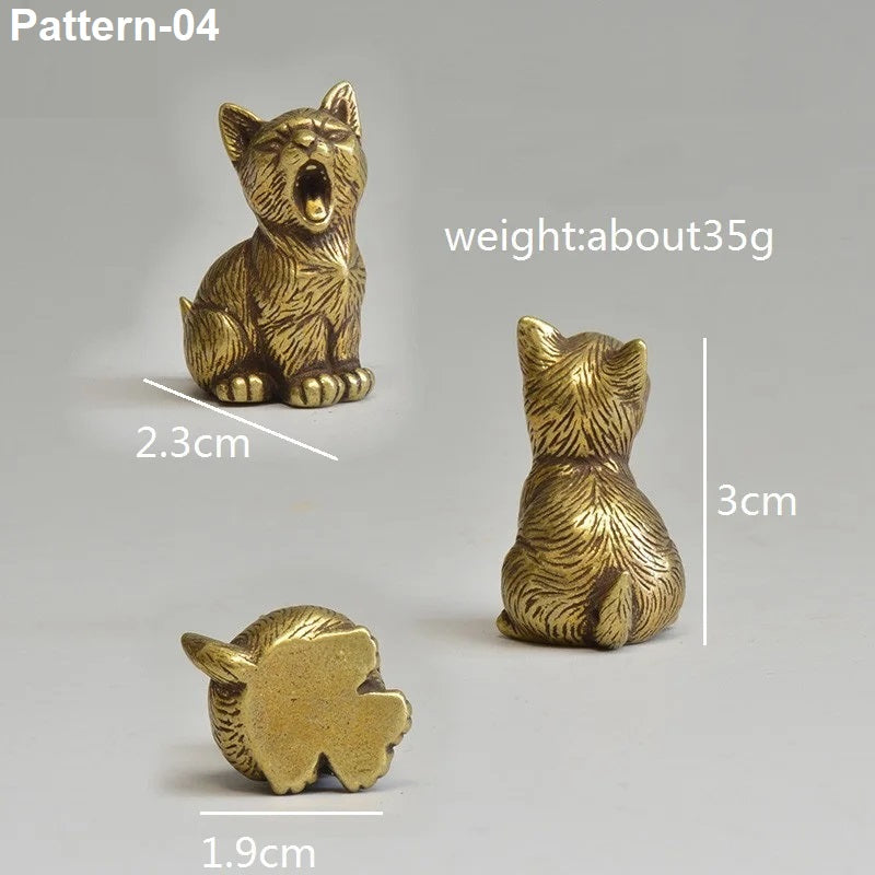 Gold-colored figurine of a sitting animal with measurements on a gray background
