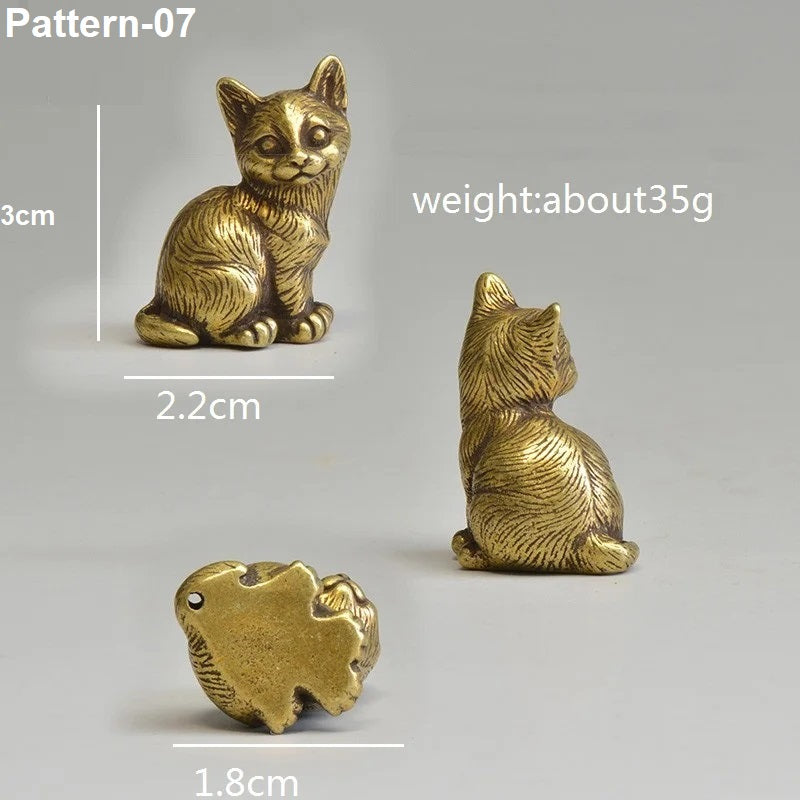 Gold cat figurines with measurements and weight information on a gray background