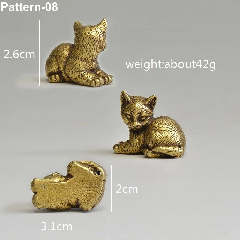 Gold cat figurine with measurements on a gray background