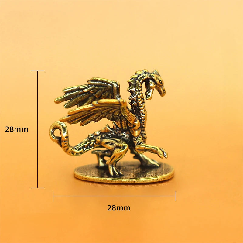 Bronze dragon figurine with dimensions on an orange background