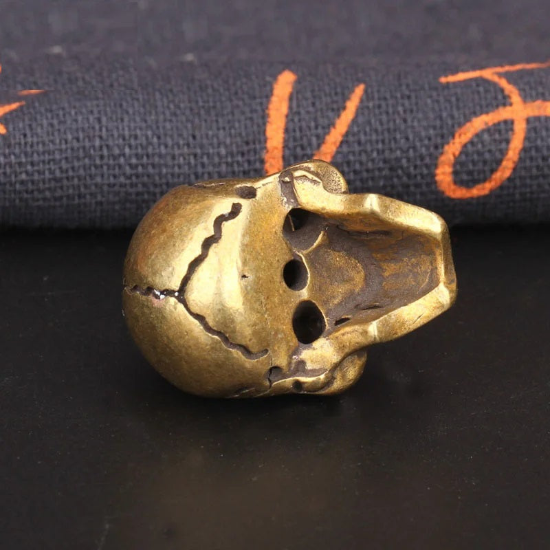 side view of Solid brass skull head figurine with antique finish for gothic home decor, office desk decoration, and collectible display