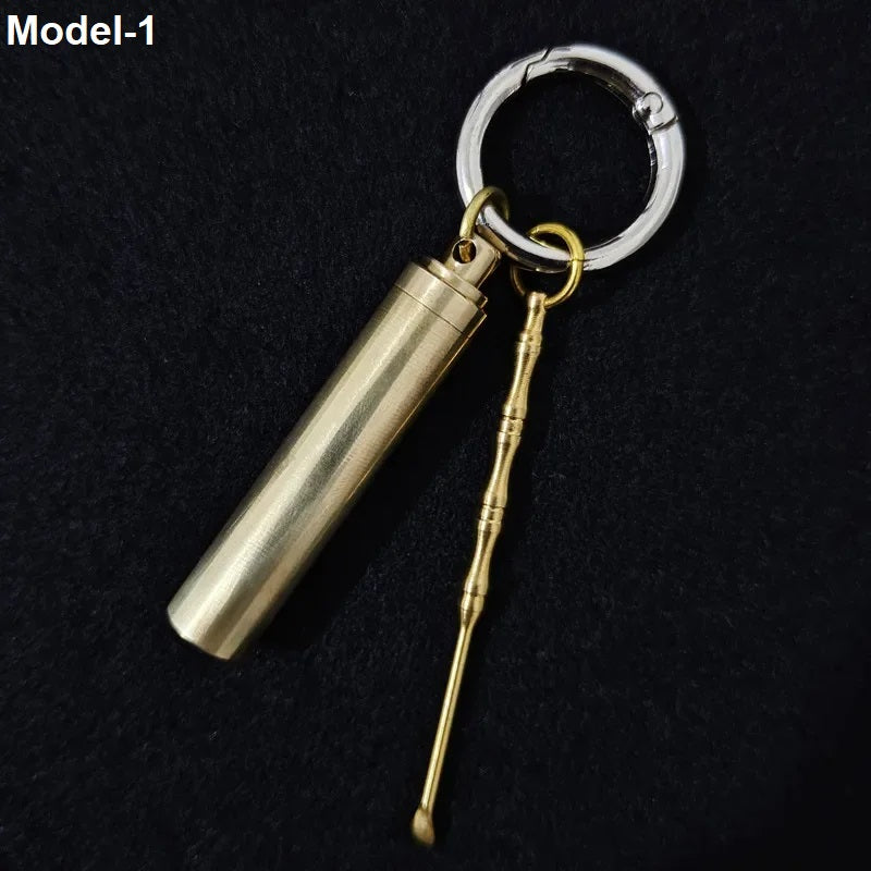 Vintage brass keychain pendant with cylindrical storage case and portable ear pick tool
