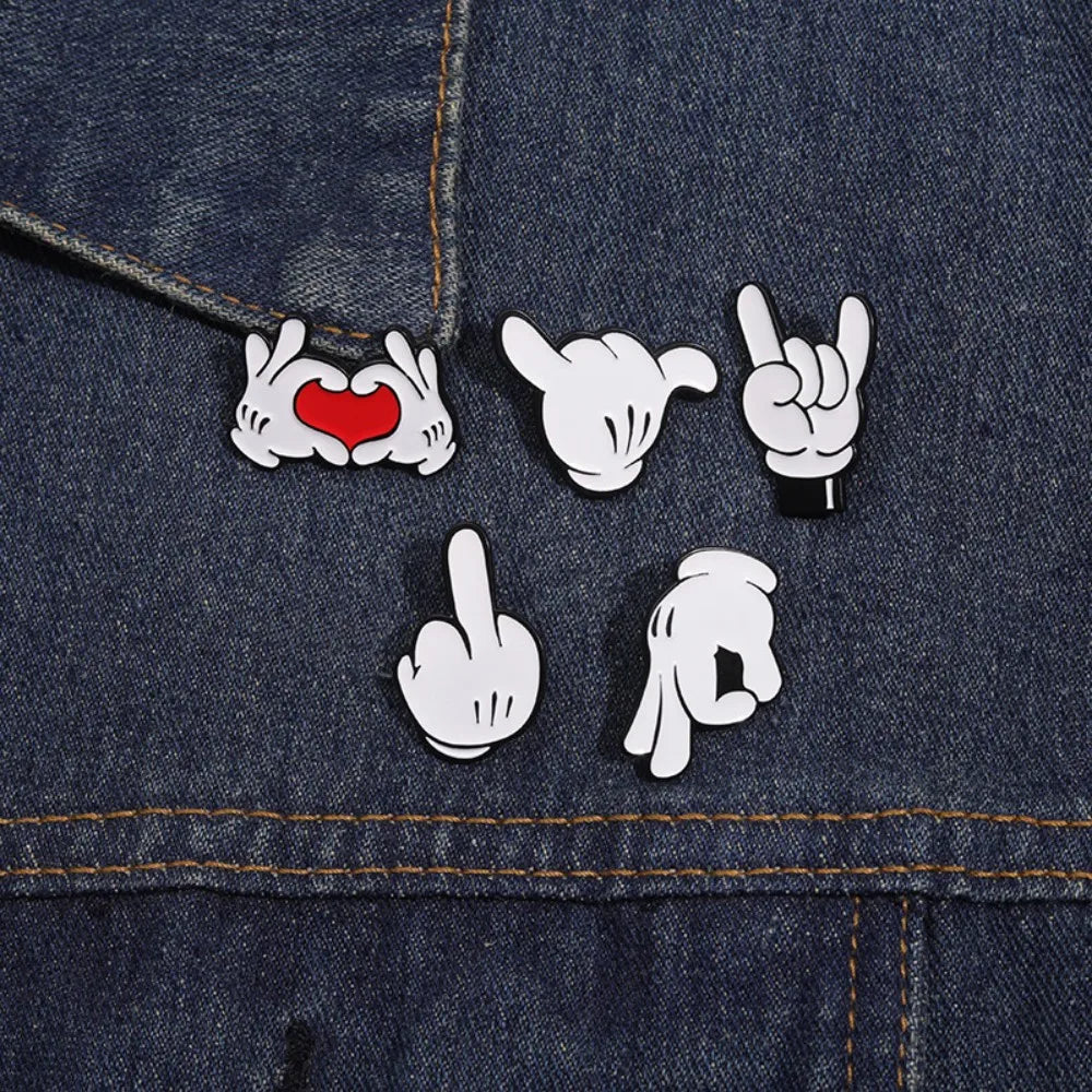 Cartoon hand gesture enamel pin collection on denim background