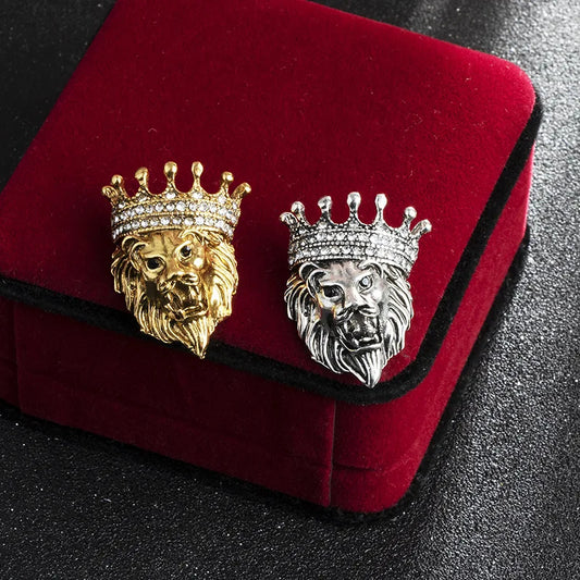 Gold and silver lion head brooch displayed on red carpet luxury fashion jewelry accessory