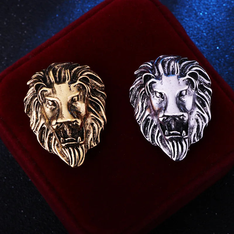Gold and silver lion head on a red cushion against a dark background