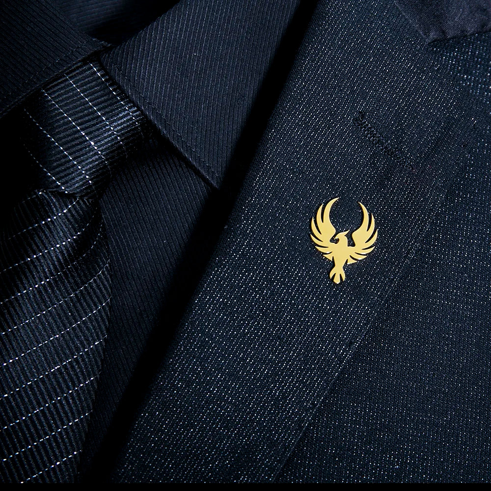 Gold emblem jewelry on navy blue fabric elegant premium fashion accessory
