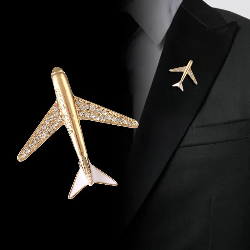 Gold airplane brooch with rhinestones attached to black suit jacket formal lapel style