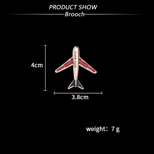 Crystal airplane brooch with size and weight details on black background.