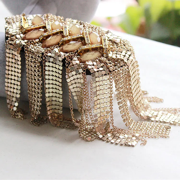Gold tassel shoulder epaulette accessory on white surface background.