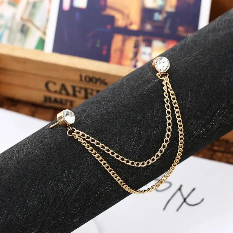 Gold crystal chain brooch attached on black sleeve fabric