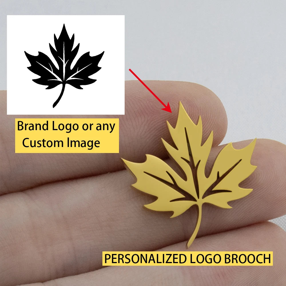 Gold leaf-shaped personalized logo brooch held between fingers with a black leaf icon and text overlay.