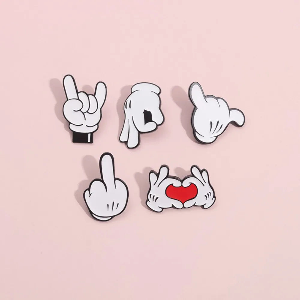 Colorful cartoon hand gesture enamel badges on pink background