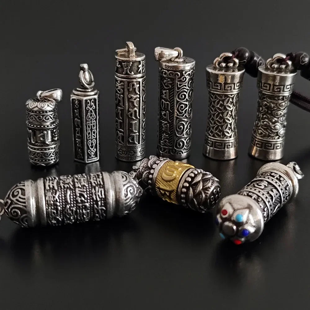 Collection of silver and gold decorative pendants on a black background