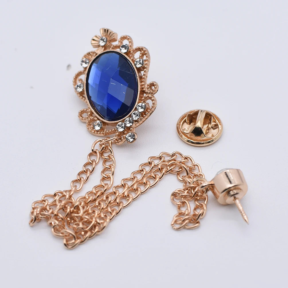 Gold brooch with blue crystal gemstone and tassel chain
