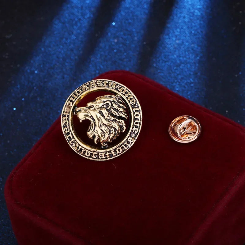 Gold lion emblem brooch on red velvet box with blue fabric background