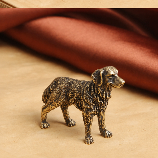 Bronze dog figurine on a beige surface with a brown fabric background