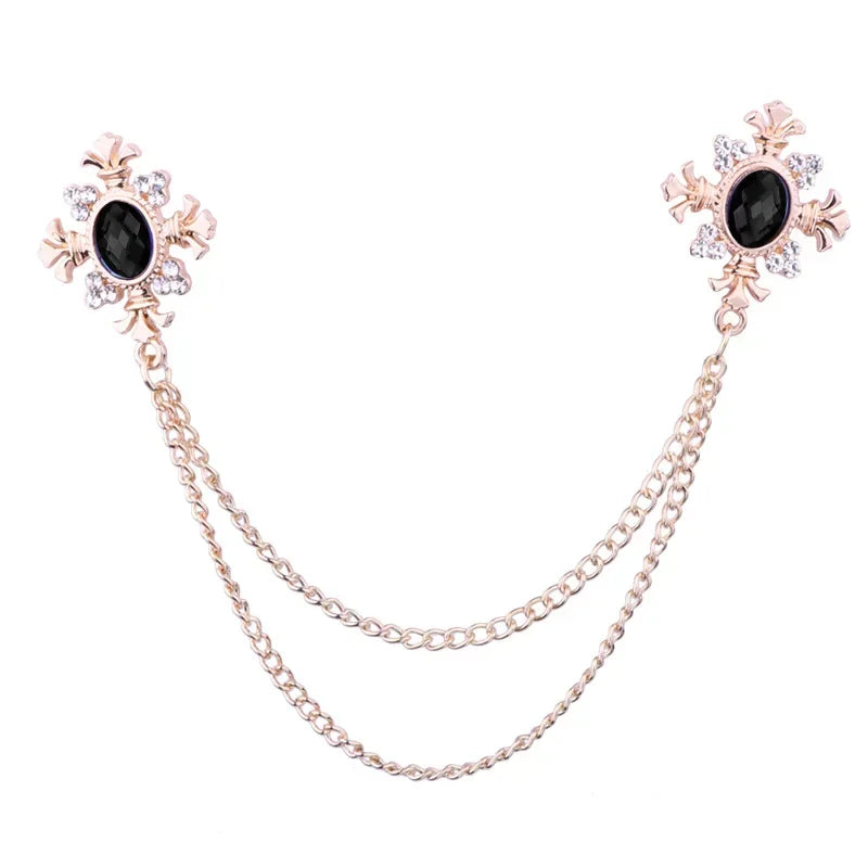 Gold Black Crystal cross chain brooch pins with gemstone accents on white background.