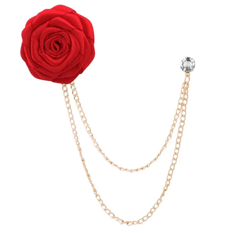 Red rose brooch with gold chain on a white background