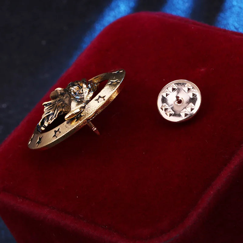 Luxury gold brooch and round lion accessory on velvet surface