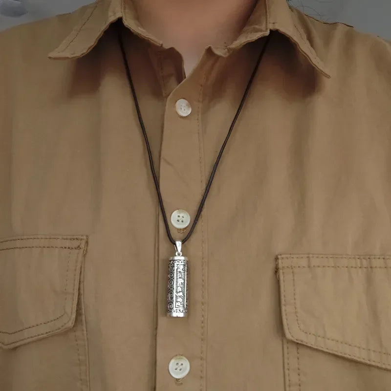 Necklace with a pendant on a beige shirt
