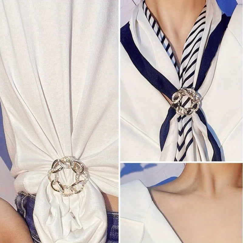Person wearing white scarf with decorative knot and elegant brooch close up fashion detail