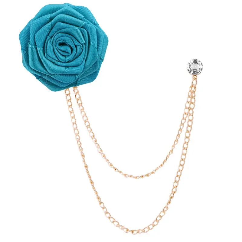 Turquoise rose-shaped brooch with gold chain on a white background